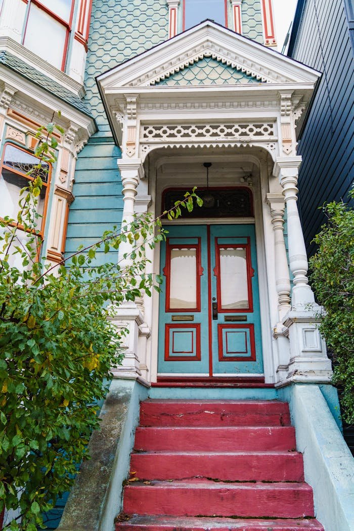 our-services-3 Elegant Victorian entrance with red steps and ornate details, perfect for architecture themes.